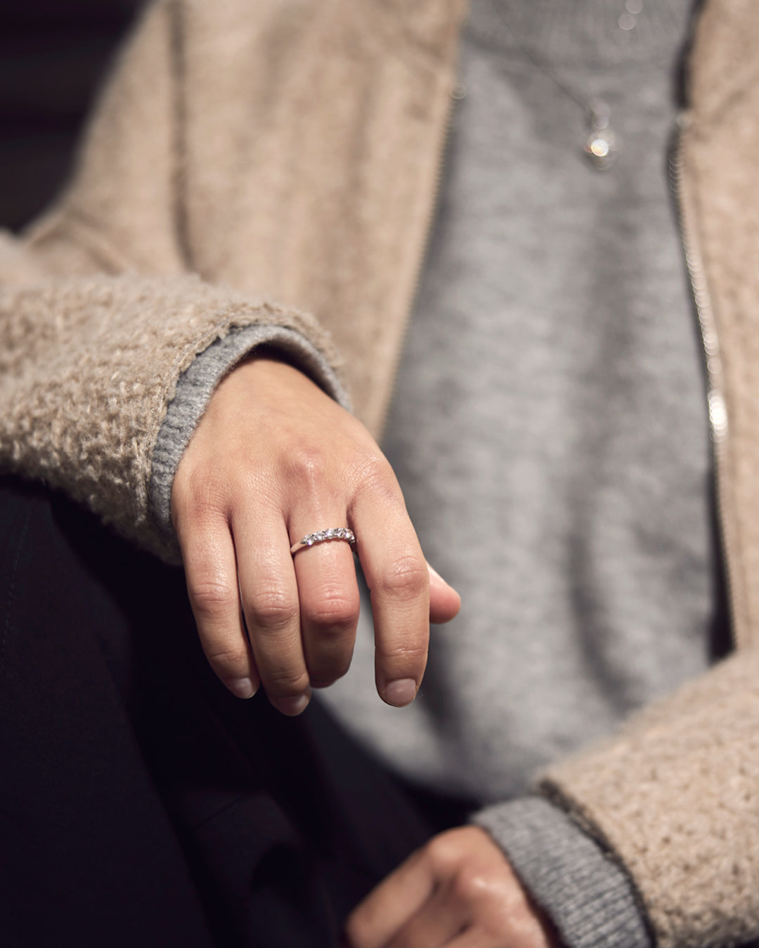 Close-up of a diamond half-eternity ring worn on hand, Robins + Robins Jewellers Plymouth.
