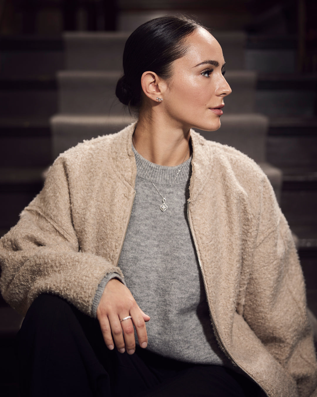 Model wearing diamond pendant necklace, stud earrings and ring at Robins + Robins jewellers in Plymouth.