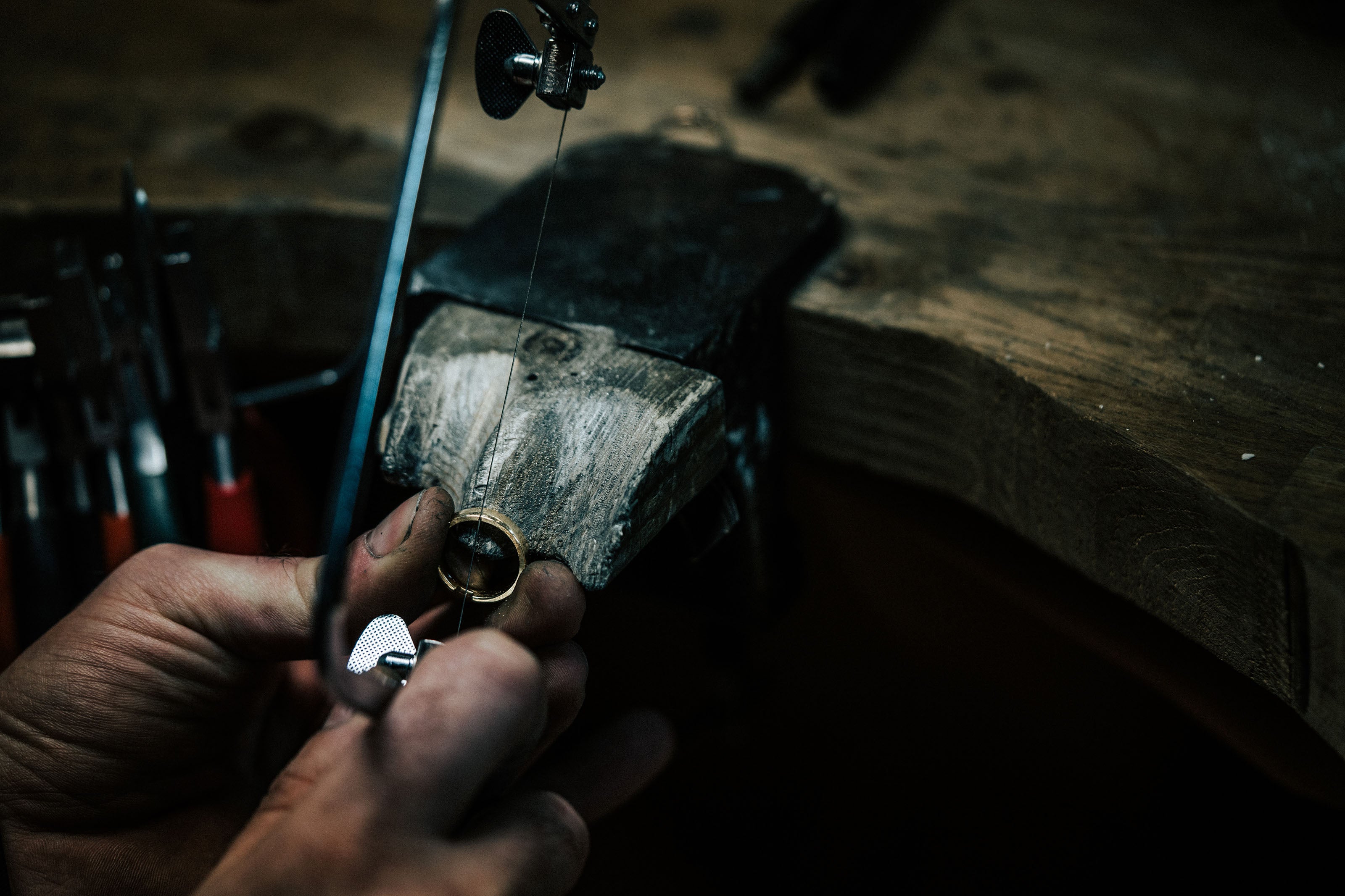 Close-up of a ring being worked on with a jeweller’s piercing saw at our Plymouth Jewellery Workshop.