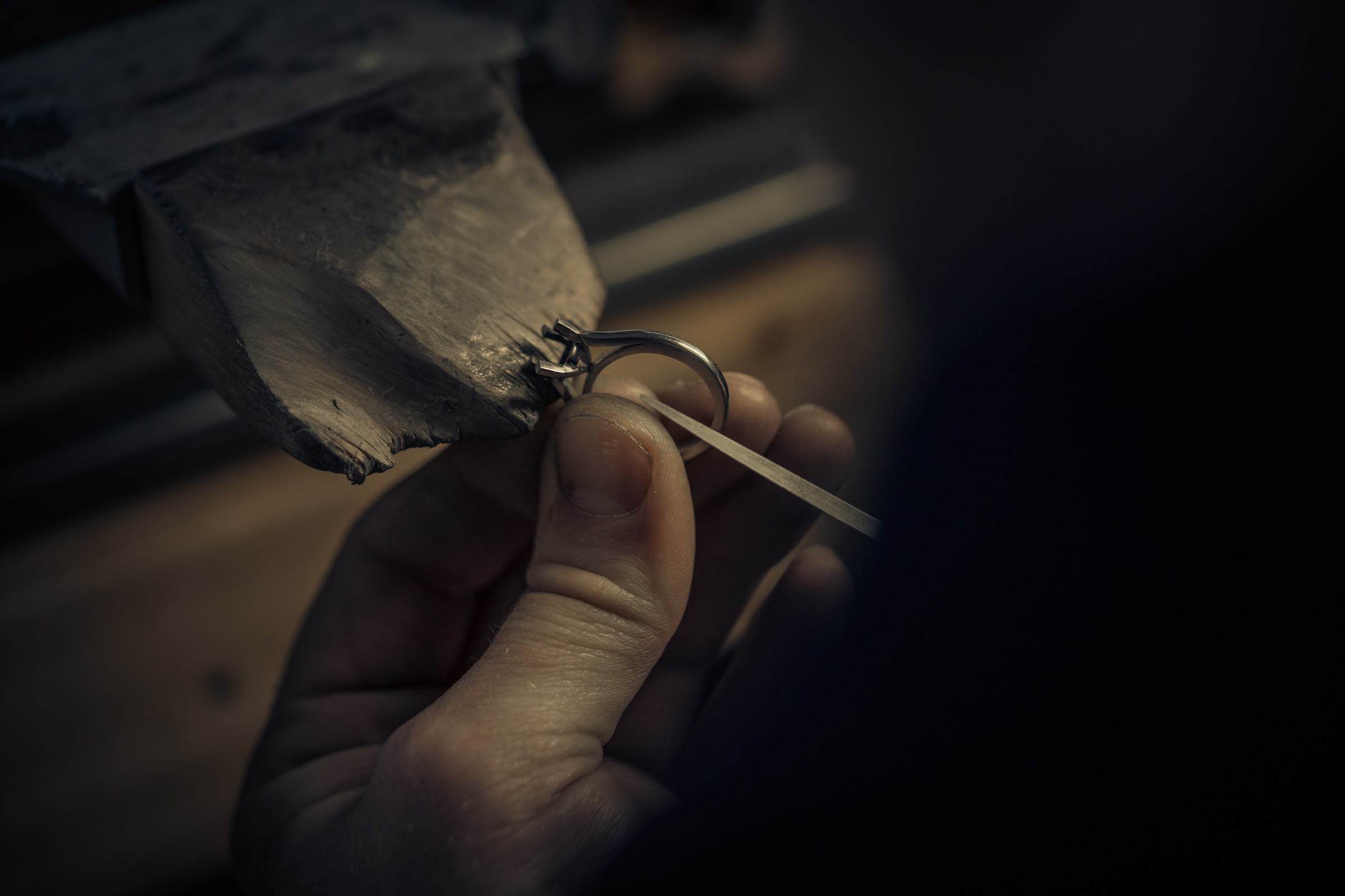 A jeweller repairing a platinum diamond ring
