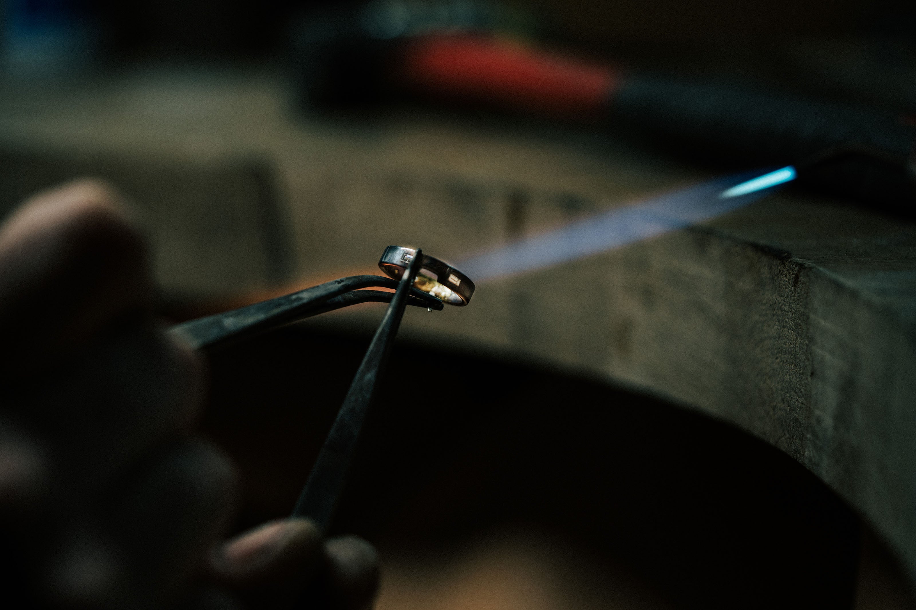Jeweller heating a ring with a torch during the jewellery-making process at our Plymouth Jewellery Repair Shop.